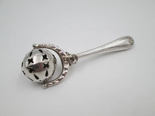 Baby rattle with handle. Sterling silver. Vegetable motifs. Openwork sphere. 1980's