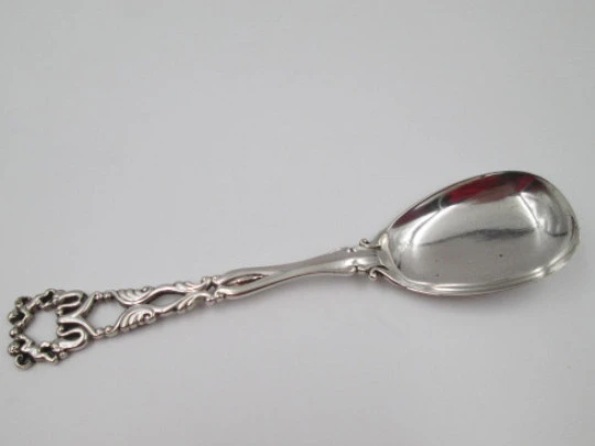 Bruckmann & Söhne long silver spoon with openwork handle. Cherub finish. 1910's