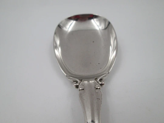 Bruckmann & Söhne long silver spoon with openwork handle. Cherub finish. 1910's