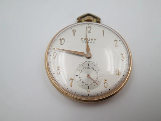 Cauny Prima. Gold plated metal. Manual wind. Small seconds hand. Ornate back. 1960's