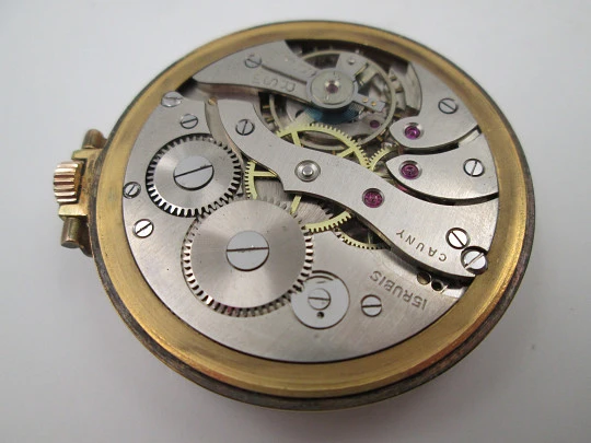 Cauny Prima. Gold plated metal. Manual wind. Small seconds hand. Ornate back. 1960's