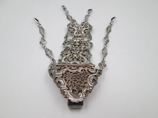 Chatelaine with four bodies. Silver copper. Belt hook and chains with carabiners. 1900's