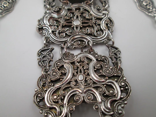 Chatelaine with four bodies. Silver copper. Belt hook and chains with carabiners. 1900's