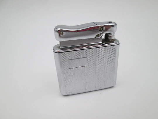 Colibri Monopol pocket petrol lighter. Silver plated. Geometric pattern. England. 1950's