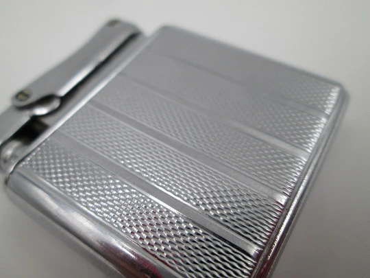 Colibri Monopol pocket petrol lighter. Silver plated. Geometric pattern. England. 1950's