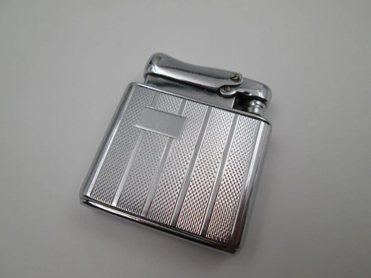 Colibri Monopol pocket petrol lighter. Silver plated. Geometric pattern. England. 1950's