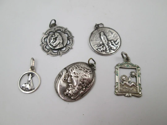 Five sterling silver religious medals collection. Jesus, virgins and saints. Spain. 1950's