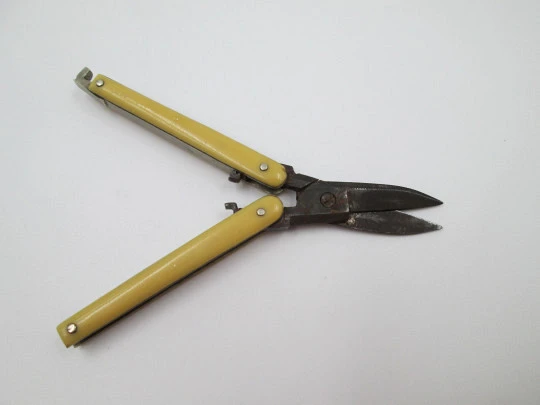 Folding pocket travel scissors. Ivory handles and wrought iron. Tab clasp. Europe. 1930's