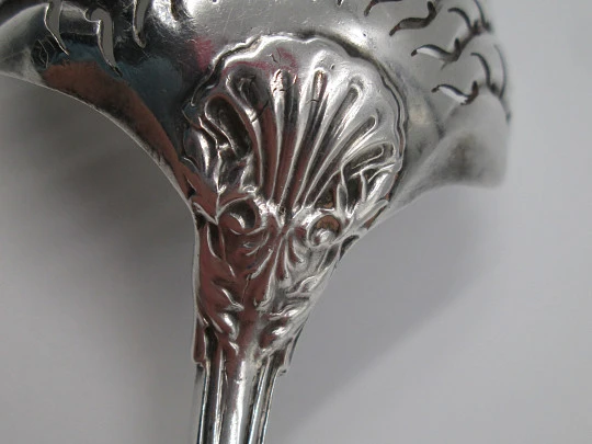 French sterling silver olive serving spoon. Ribbed motifs and shells. Openwork bowl