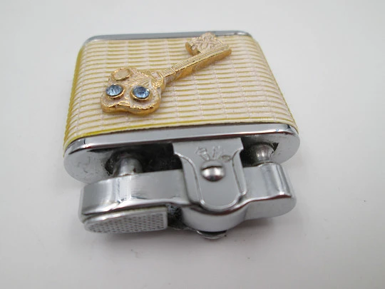 Golden Bell automatic pocket petrol lighter. Chromed plated and white resin. Japan. 1960's