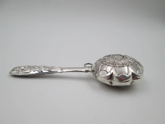 Hand baby rattle. 925 sterling silver. Floral and vegetable motifs. Ring on handle. Spain. 1990's