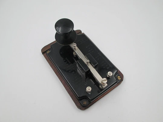 Merit morse code key with alphabet. Black bakelite and wood stand. England. 1950's