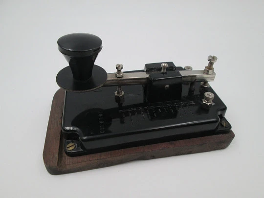 Merit morse code key with alphabet. Black bakelite and wood stand. England. 1950's