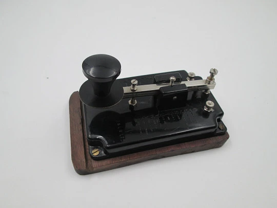 Merit morse code key with alphabet. Black bakelite and wood stand. England. 1950's