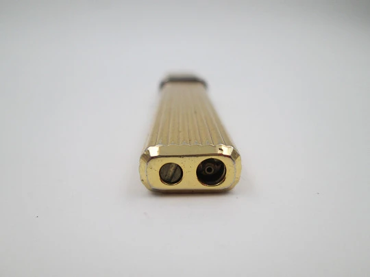 Mica pocket butane lighter. Gold plated and silver metal. Linear pattern. South America