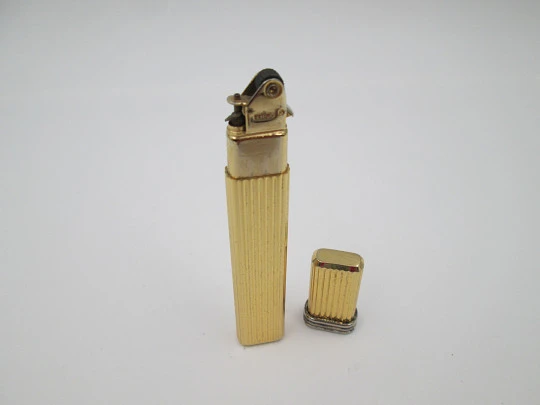 Mica pocket butane lighter. Gold plated and silver metal. Linear pattern. South America