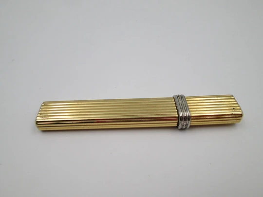 Mica pocket butane lighter. Gold plated and silver metal. Linear pattern. South America