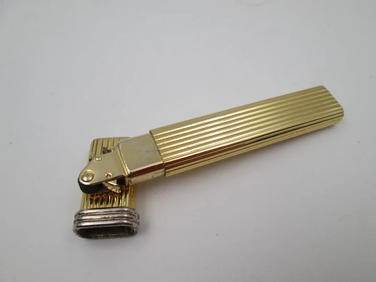 Mica pocket butane lighter. Gold plated and silver metal. Linear pattern. South America