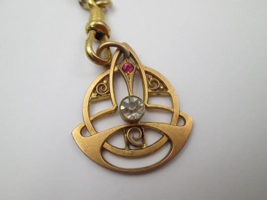 Modernist pocket watch chain with pendant. Gold plated metal and colours gems. 1920's