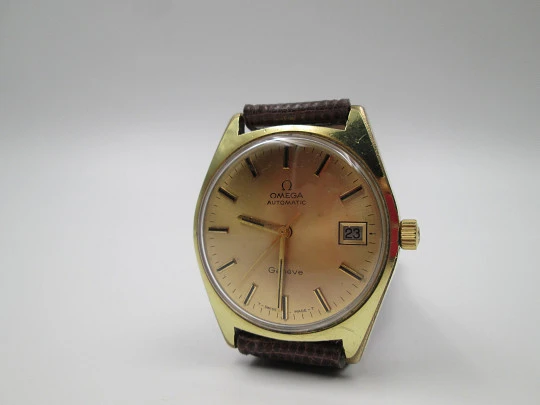 Omega Genève. 20 micron gold plated and steel. Automatic. Calendar. Strap. 1960's