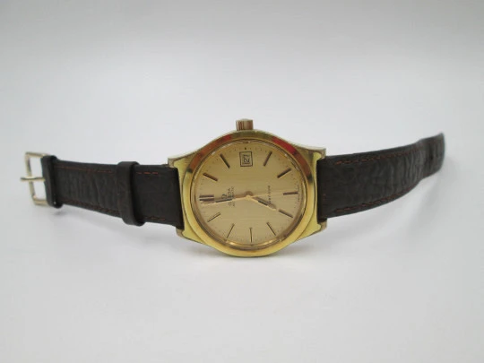 Omega Genève. 20 micron gold plated and steel. Automatic. Calendar. Strap. 1970's