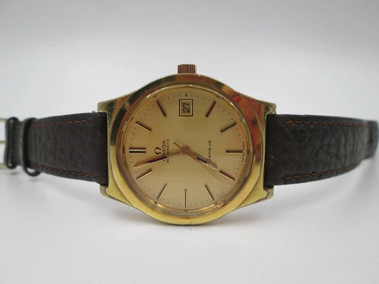 Omega Genève. 20 micron gold plated and steel. Automatic. Calendar. Strap. 1970's