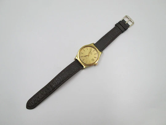 Omega Genève. 20 micron gold plated and steel. Automatic. Calendar. Strap. 1970's