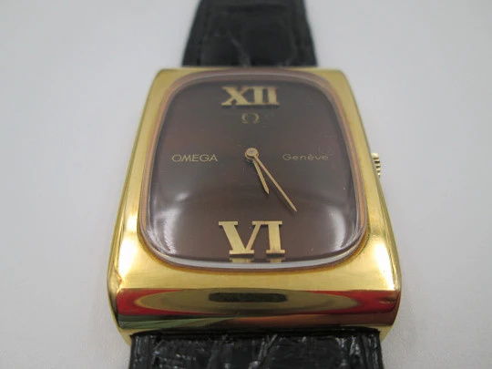 Omega Genève. Gold plated and steel. Manual wind. Tiger's eye dial. Original box. 1970's