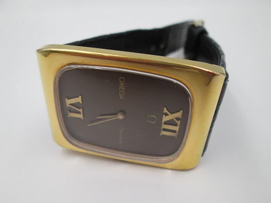 Omega Genève. Gold plated and steel. Manual wind. Tiger's eye dial. Original box. 1970's