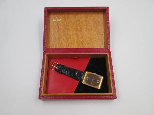 Omega Genève. Gold plated and steel. Manual wind. Tiger's eye dial. Original box. 1970's