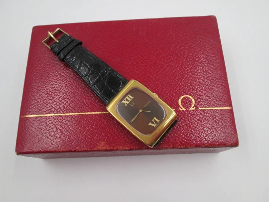 Omega Genève. Gold plated and steel. Manual wind. Tiger's eye dial. Original box. 1970's