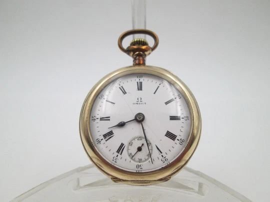 Omega open-faced pocket watch. Gold plated metal. Stem-wind. Porcelain dial. 1900's. Swiss