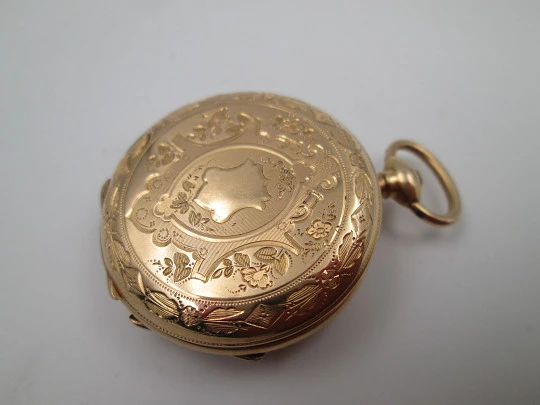 Open-face pocket watch. 14 karat yellow gold. Key-wind movement. Floral motifs. 1890's