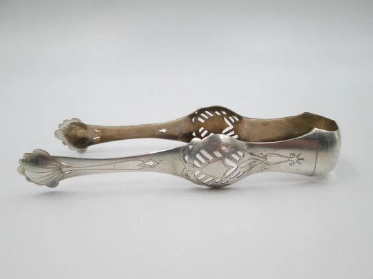 Ornate ice tongs. Sterling silver. Openwork design. Geometric chiseled and shells. 1950's