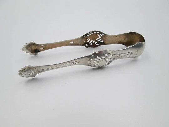 Ornate ice tongs. Sterling silver. Openwork design. Geometric chiseled and shells. 1950's