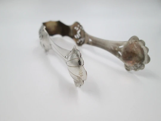 Ornate ice tongs. Sterling silver. Openwork design. Geometric chiseled and shells. 1950's