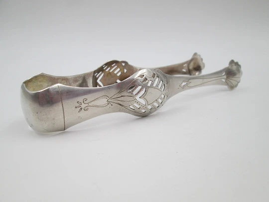 Ornate ice tongs. Sterling silver. Openwork design. Geometric chiseled and shells. 1950's