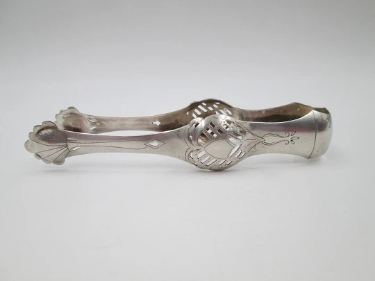 Ornate ice tongs. Sterling silver. Openwork design. Geometric chiseled and shells. 1950's