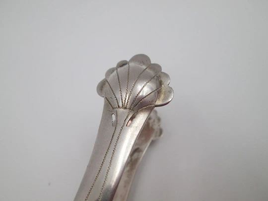 Ornate ice tongs. Sterling silver. Openwork design. Geometric chiseled and shells. 1950's