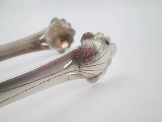 Ornate ice tongs. Sterling silver. Openwork design. Geometric chiseled and shells. 1950's