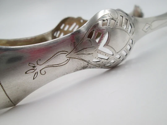 Ornate ice tongs. Sterling silver. Openwork design. Geometric chiseled and shells. 1950's