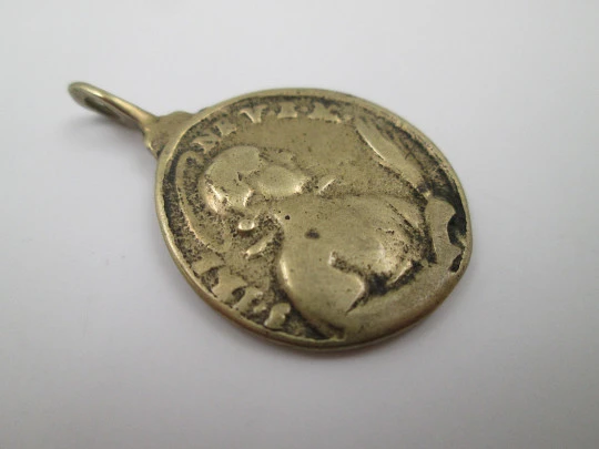 Oval bronze relief medal. Saint Barbara and hermitage. Turned ring on top. 19th century