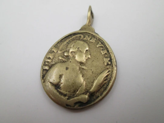 Oval bronze relief medal. Saint Barbara and hermitage. Turned ring on top. 19th century
