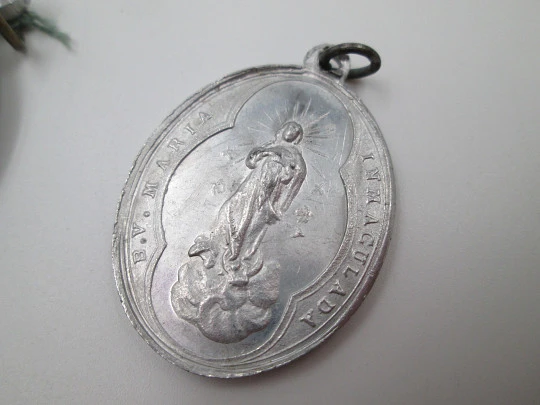 Pair of aluminum religious medals. Saint Joseph and Immaculate Conception. 1950's