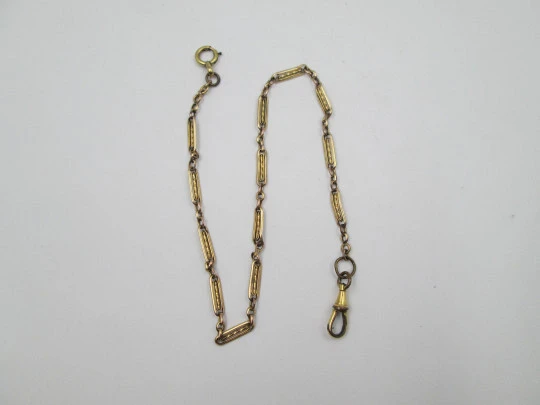 Pocket watch chain. Gold plated metal. Rectangles and spiral bars. Spring ring clasp