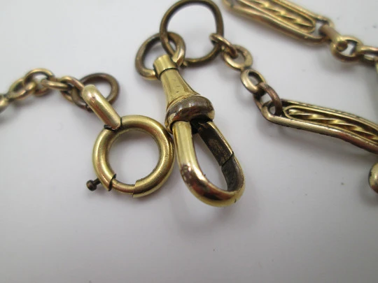 Pocket watch chain. Gold plated metal. Rectangles and spiral bars. Spring ring clasp