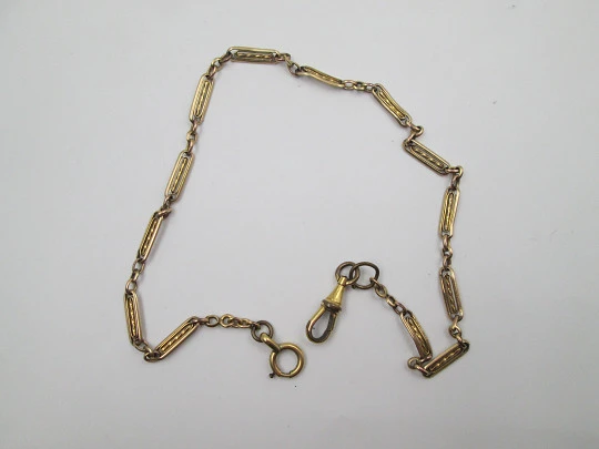 Pocket watch chain. Gold plated metal. Rectangles and spiral bars. Spring ring clasp