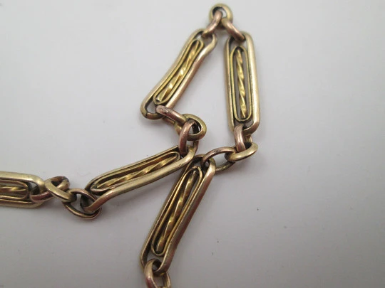 Pocket watch chain. Gold plated metal. Rectangles and spiral bars. Spring ring clasp