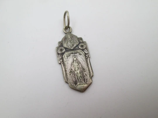 Religious medal. Virgin Mary and Jesus Christ. Silver plated metal. Ring on top. Spain. 1940's