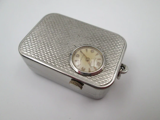 Reloj colgante R. Jaquet Genève con caja de música. Metal plateado. Cuerda manual. 1940